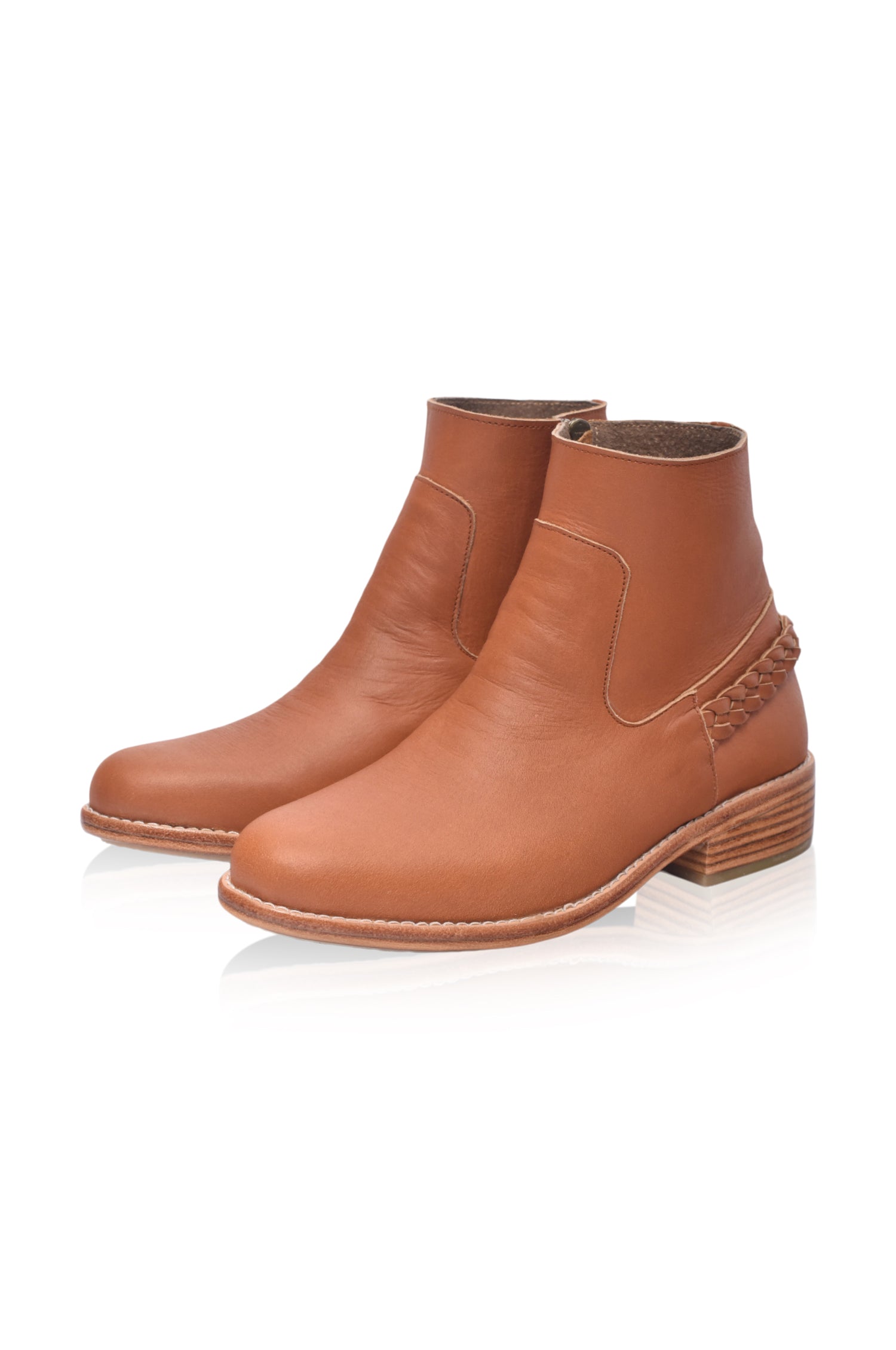 Pair of brown leather ankle boots on a white background