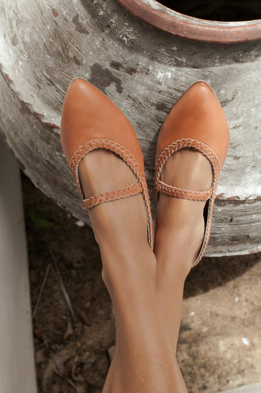 Pair of brown leather shoes on a stone surface