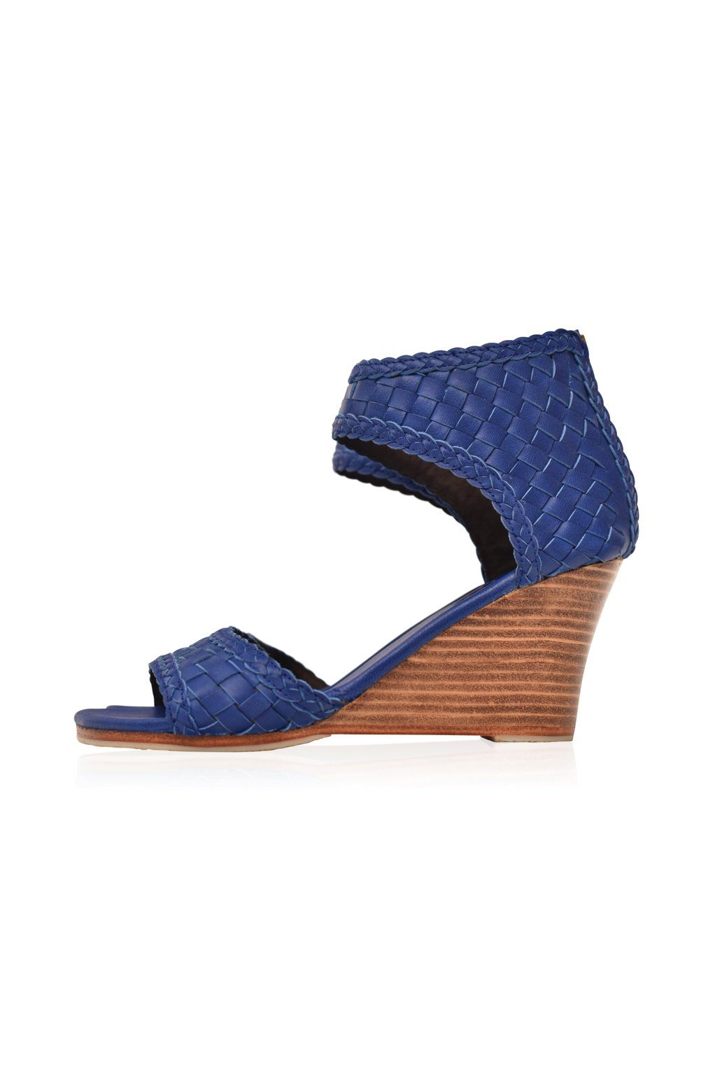 Blue wedge sandal with woven design on a white background
