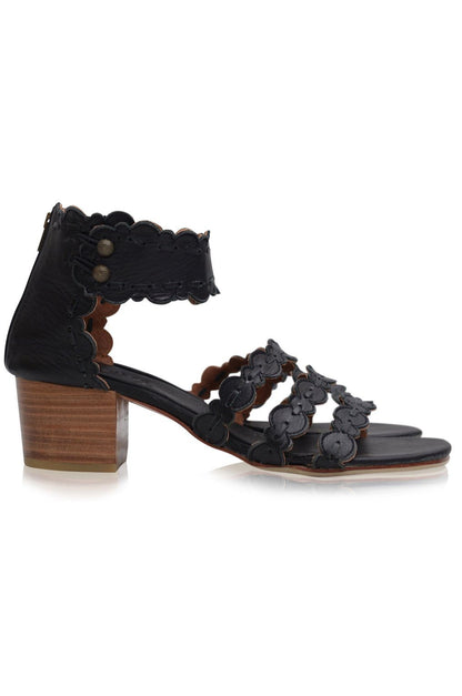 Black sandal with floral details and wooden heel on a white background