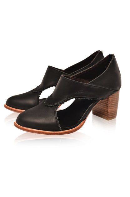 Black high-heeled shoes with wooden heel on a white background