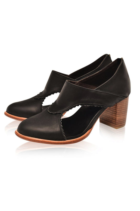 Black high-heeled shoes with wooden heel on a white background