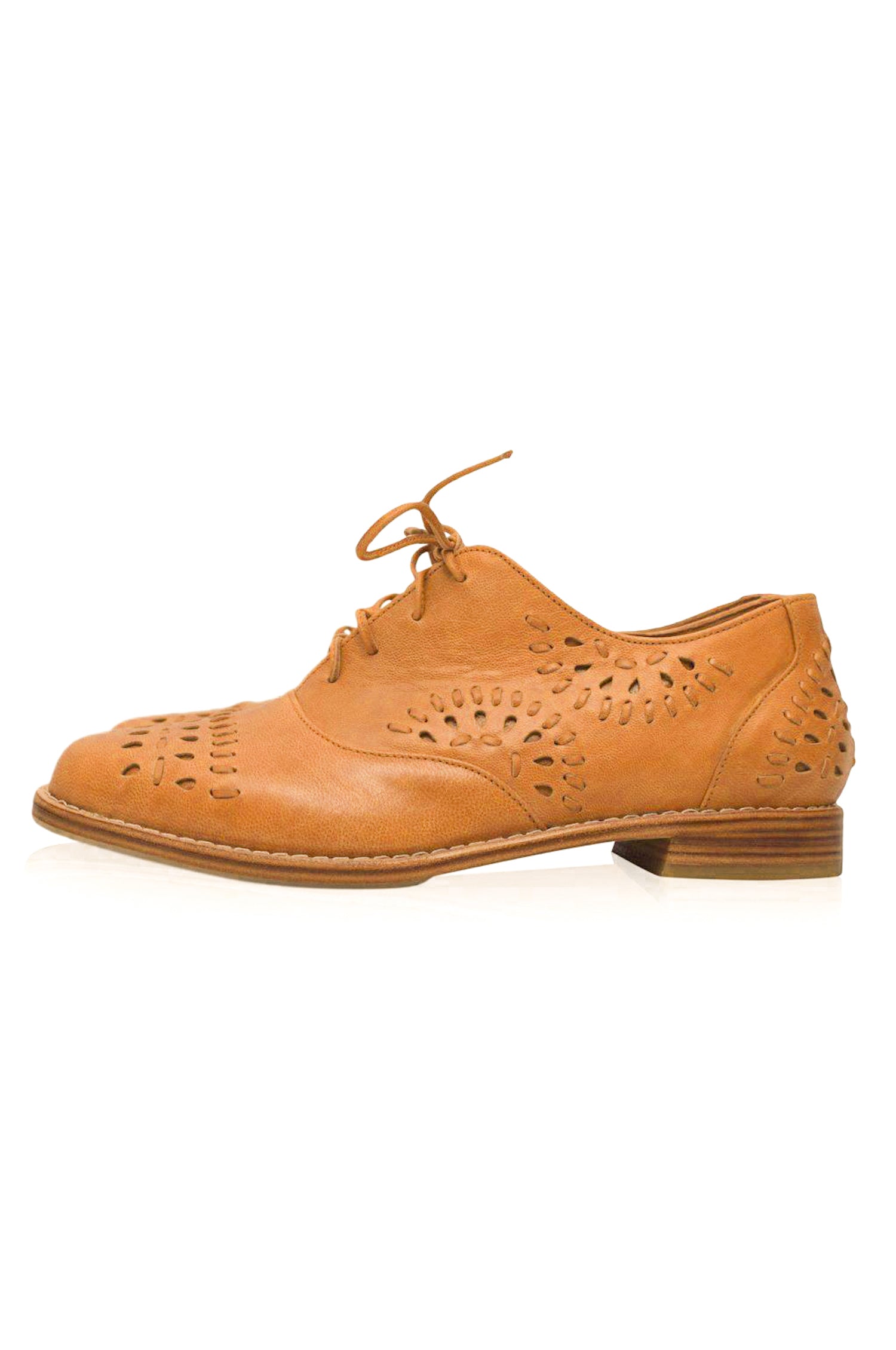 Tan leather shoe with perforated design on a white background