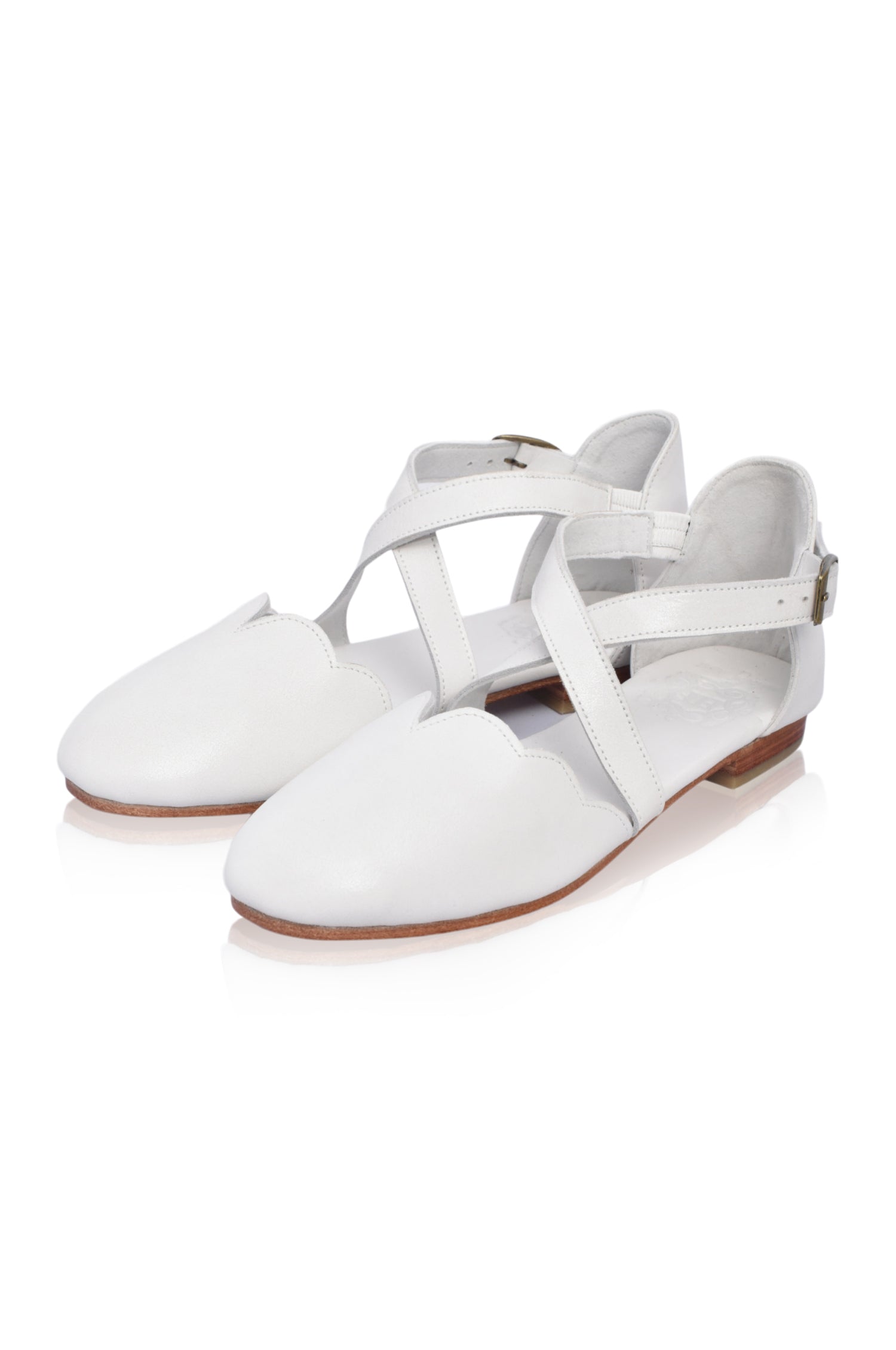 White sandals with thin straps on a white background