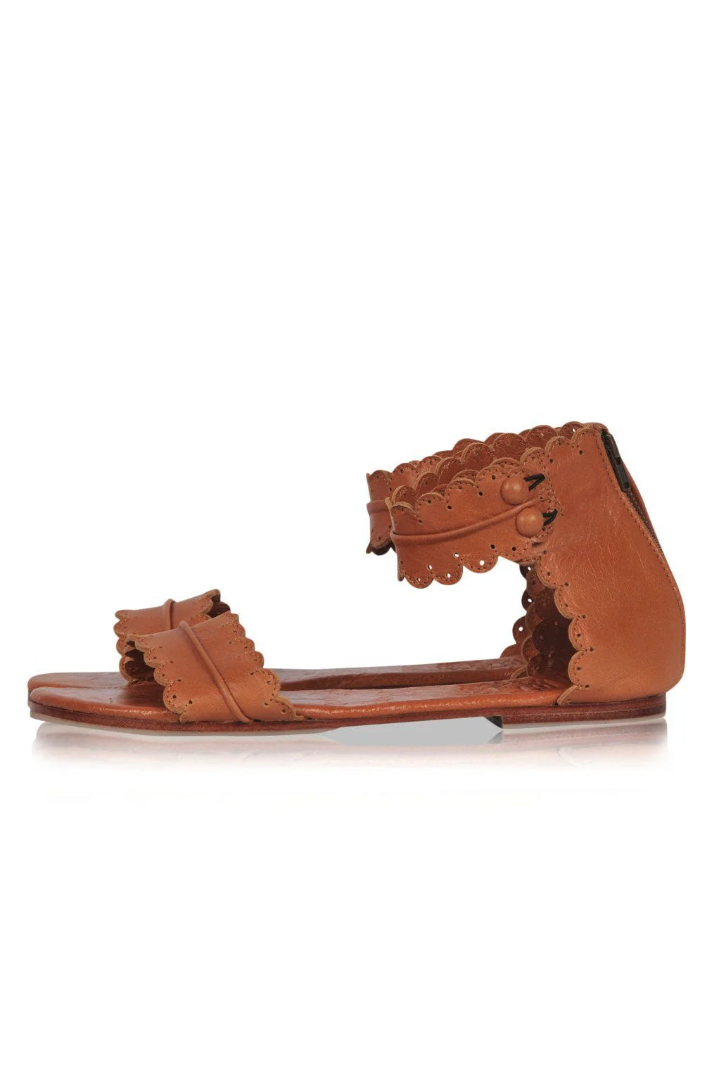 Brown sandal with decorative straps on a white background