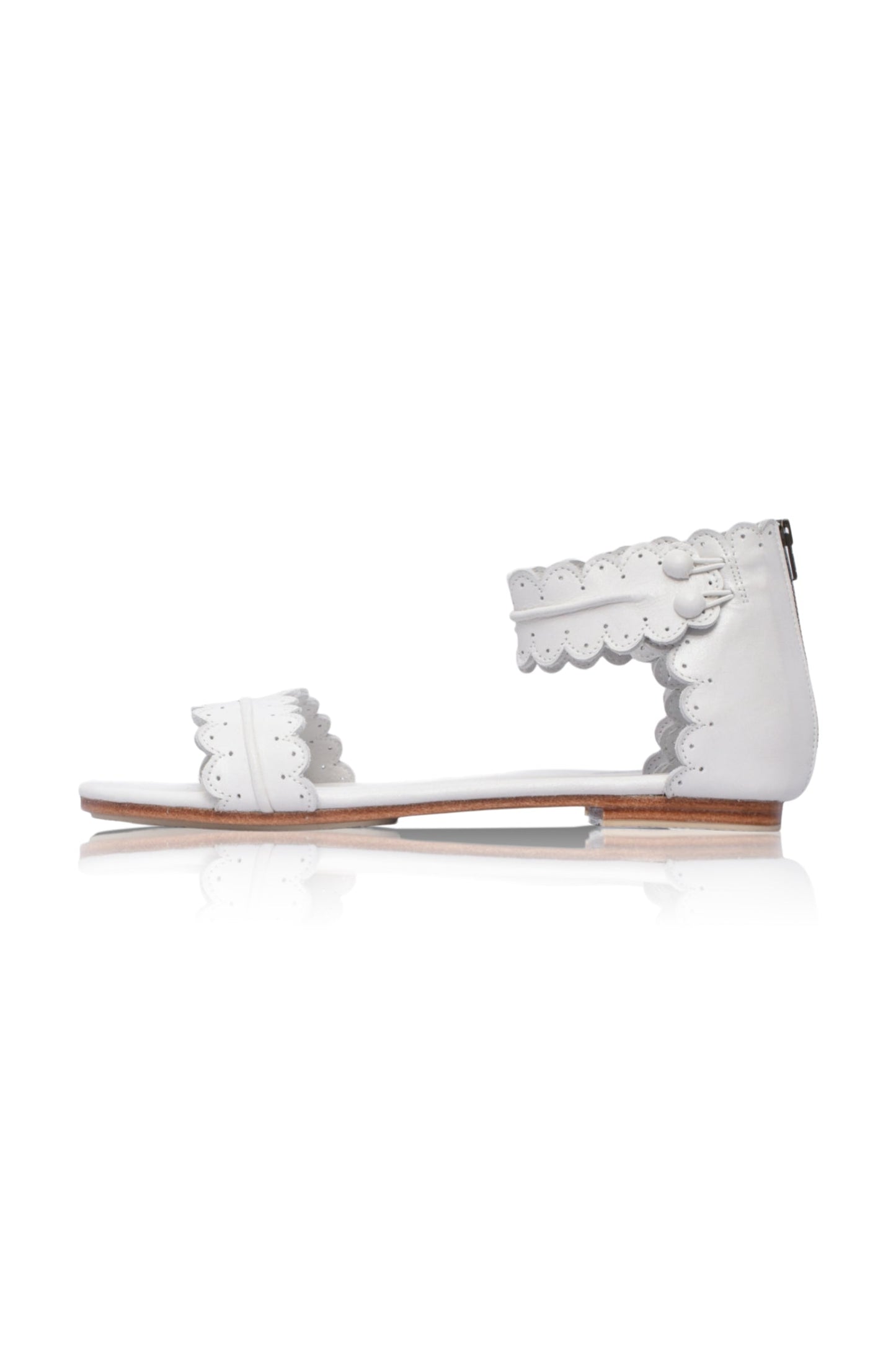 White sandal with lace details on a white background