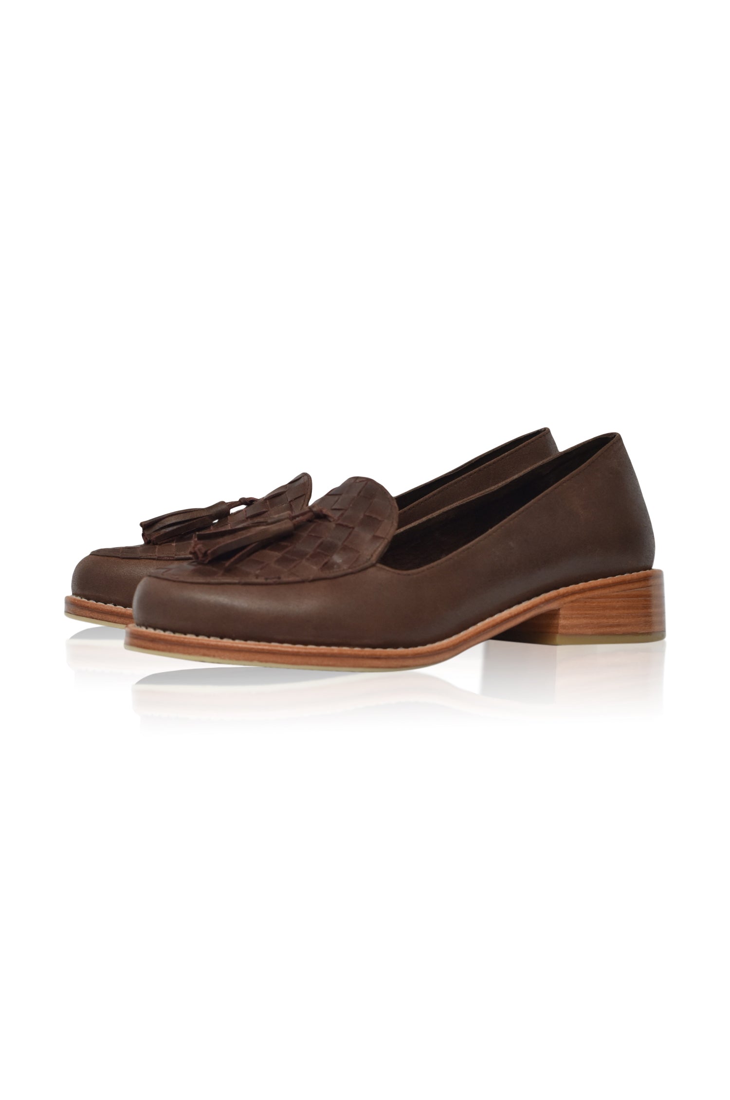 Pair of brown loafers with tassels on a white background