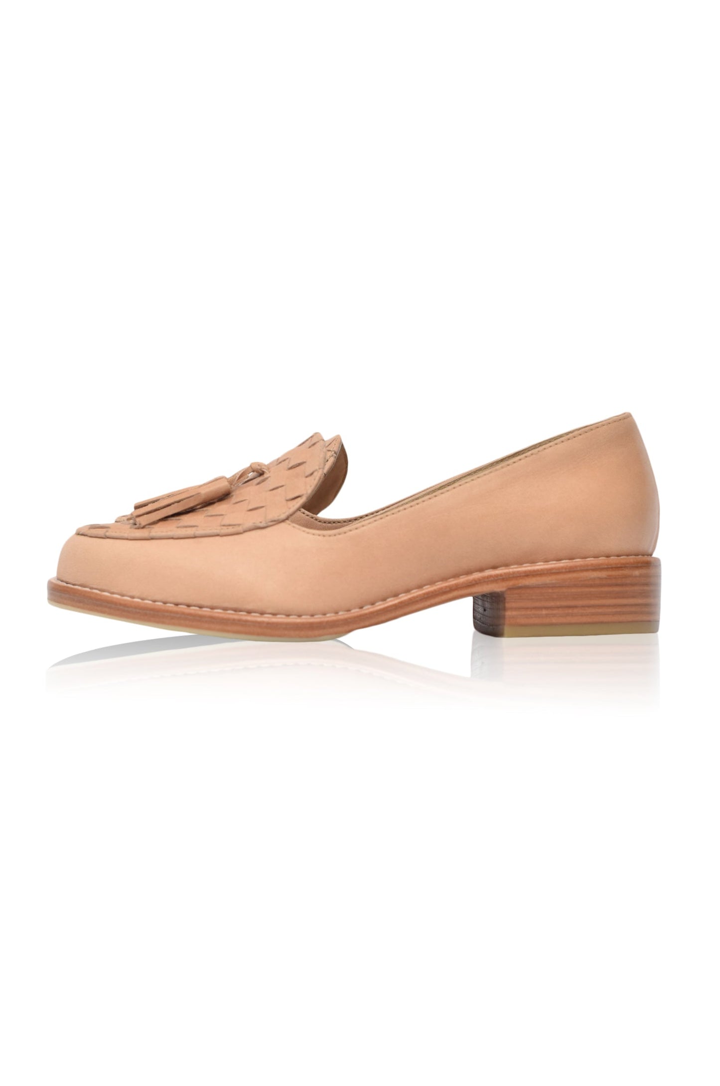 Tan loafers with tassels on a white background