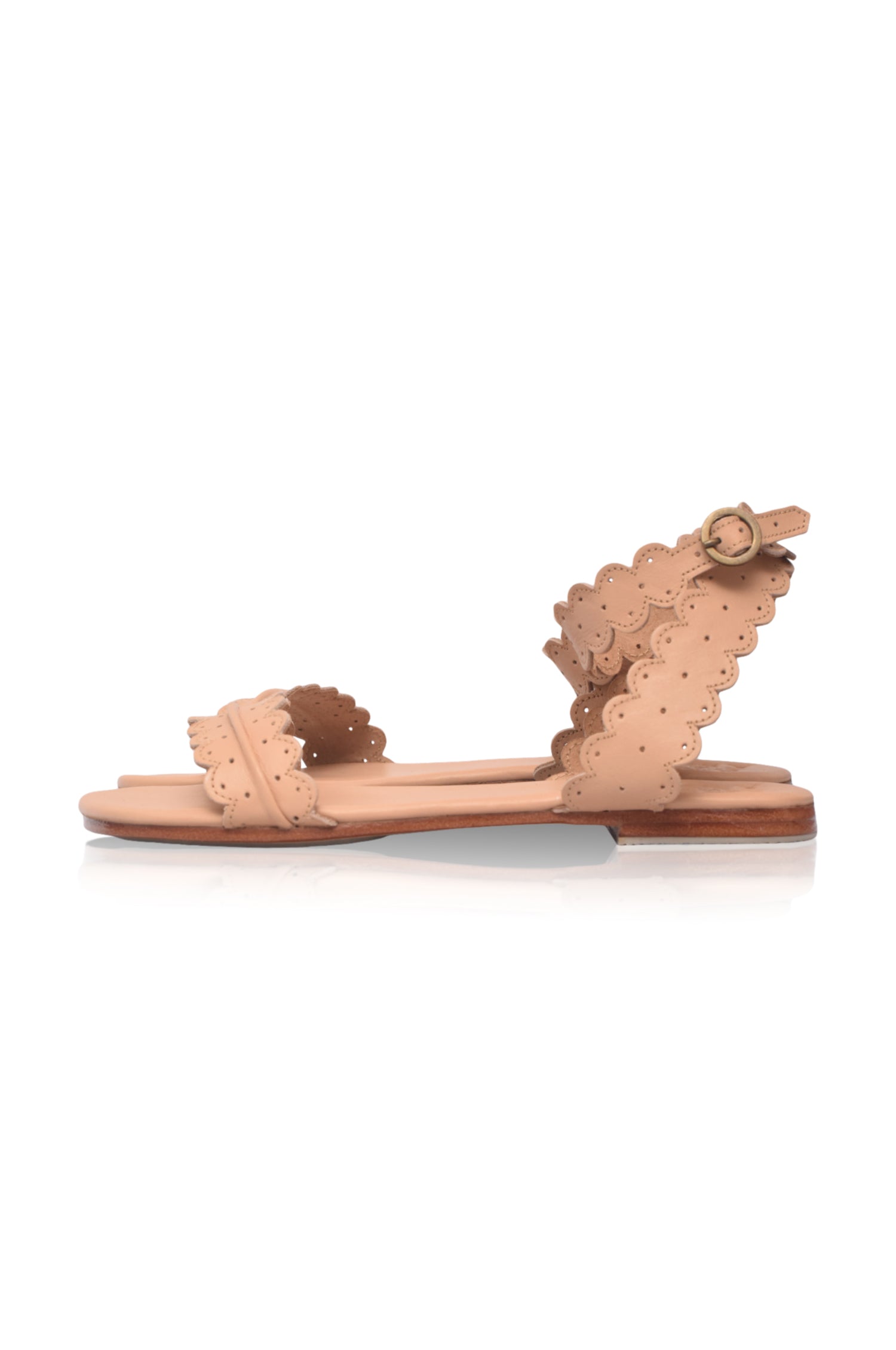 Beige sandal with scalloped edges on a white background