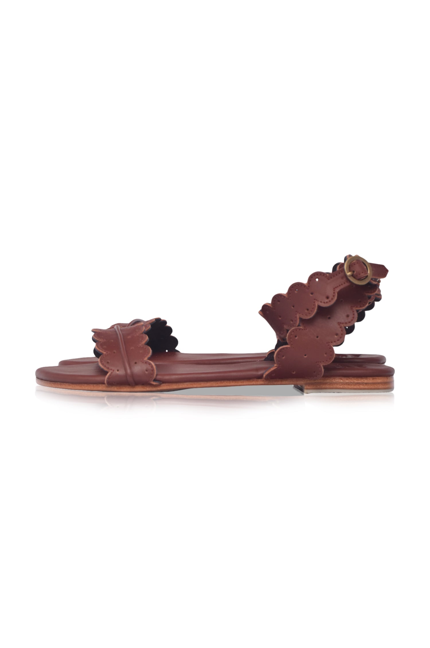 Brown sandal with floral design on a white background