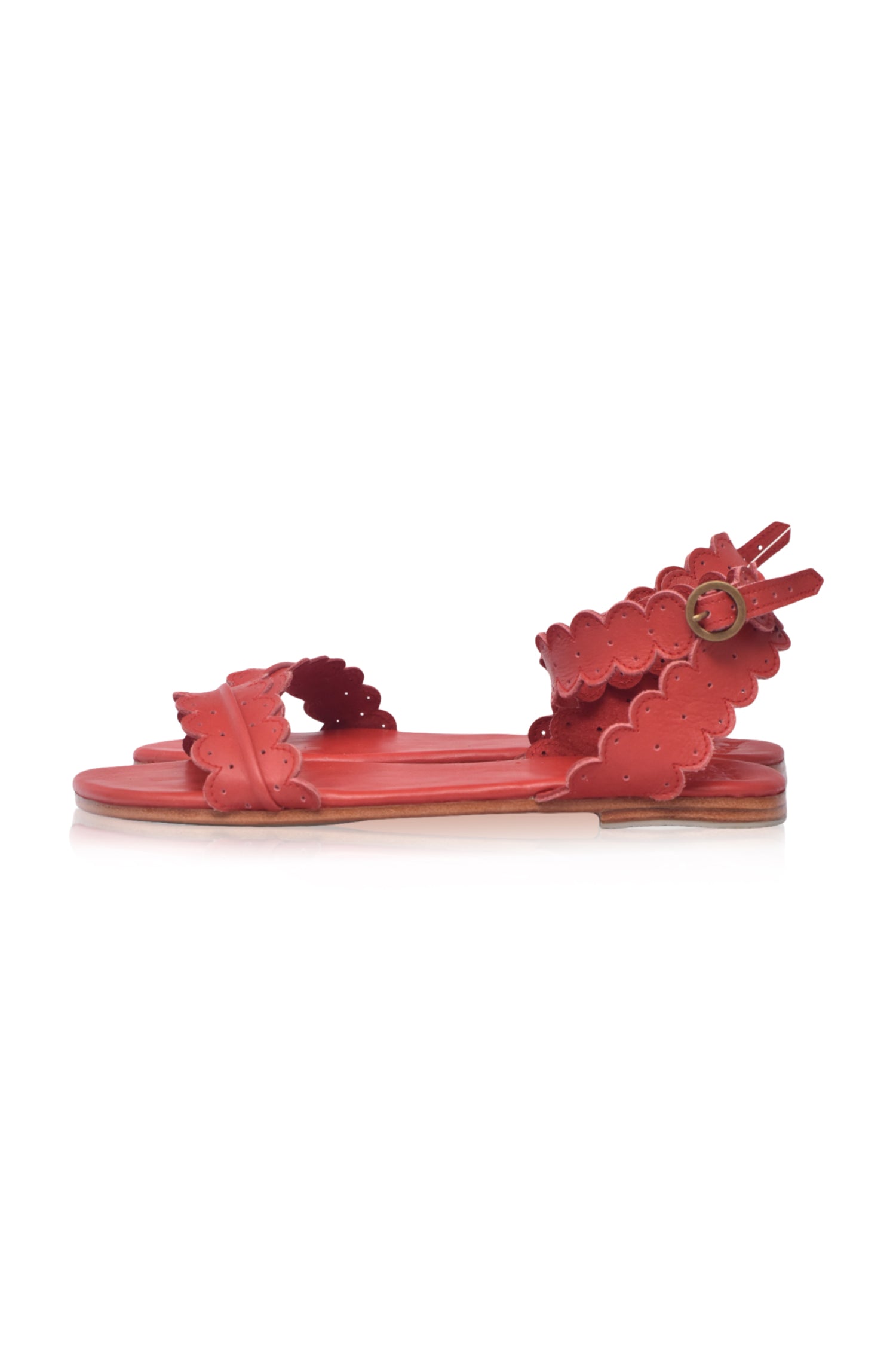 Red sandal with floral design on a white background