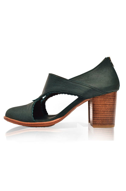 Green shoe with wooden heel on a white background