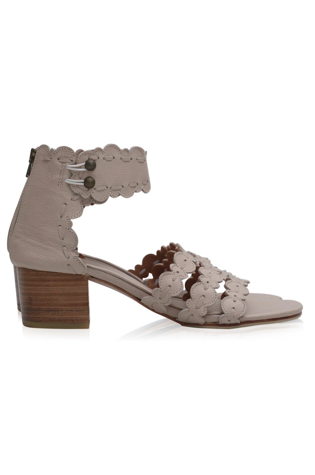 Beige sandal with floral lace details on a white background