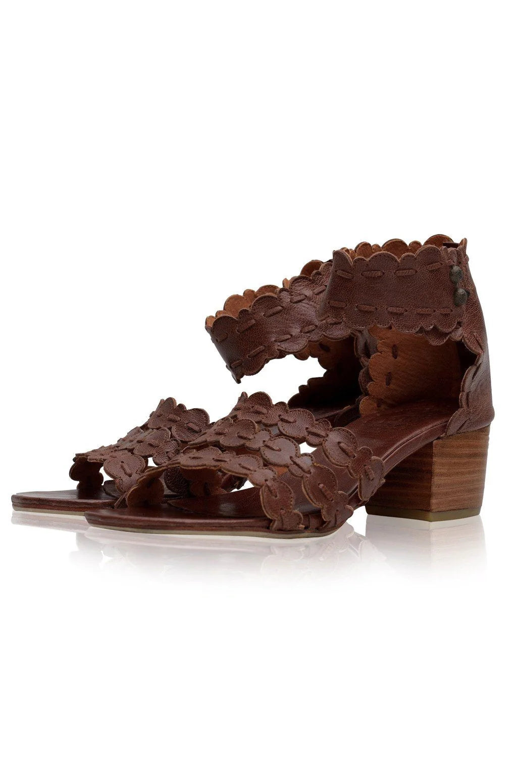 Brown sandal with intricate cut-out design on a white background
