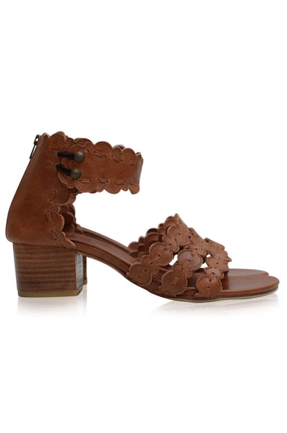 Brown sandal with floral lace-up design on a white background