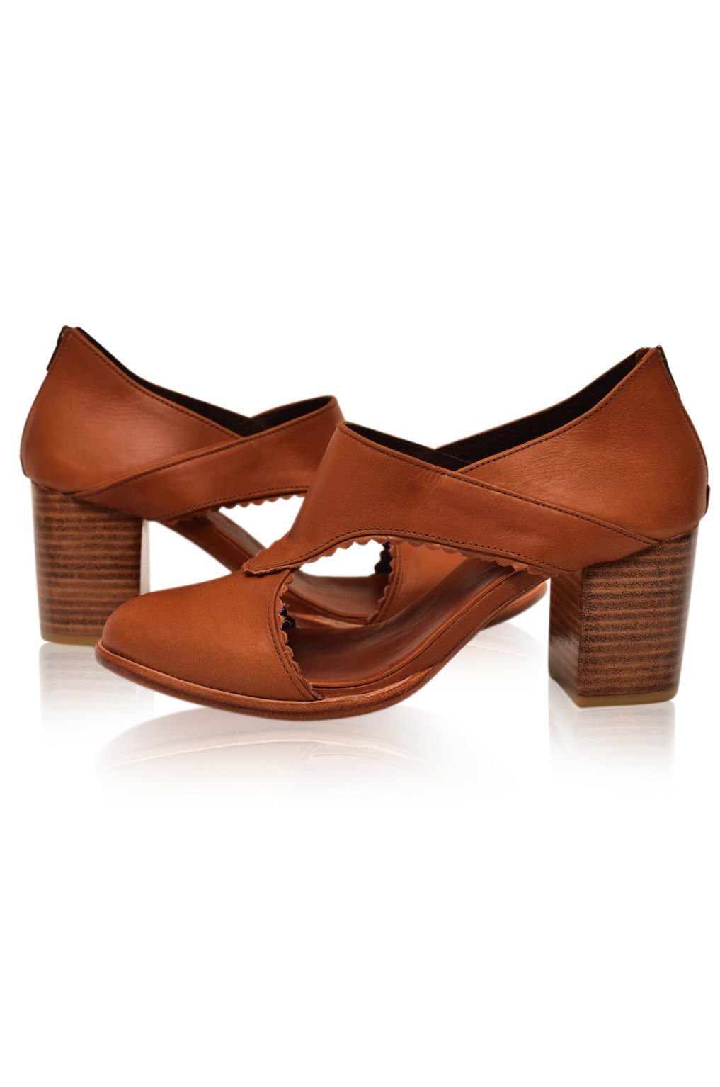 Pair of brown open-toe shoes with block heels on a white background